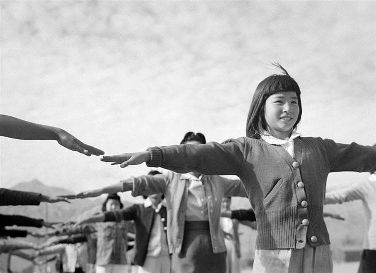 Female interns practicing calisthenics at Manzanar internment camp — Ansel Adams